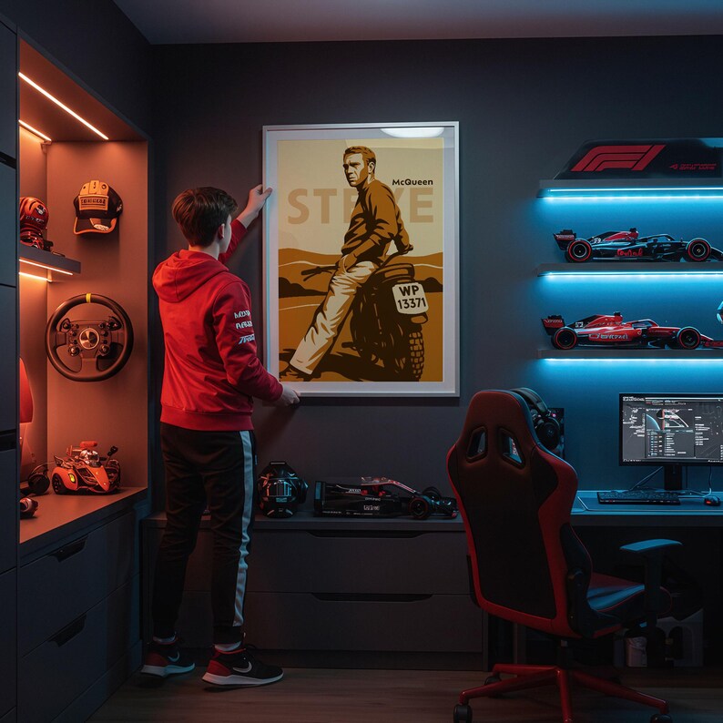 May include: A framed poster featuring Steve McQueen on a motorcycle, with the name "McQueen" and the word "STEVE" visible. The poster is in a room with racing car models, a steering wheel, and a computer setup. The room is lit with orange and blue lights.