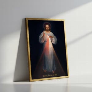 May include: A framed religious print featuring a depiction of Jesus with a halo, dressed in white robes. Light emanates from his chest, with the text "Jesus, I trust in You" at the bottom. The frame is gold.