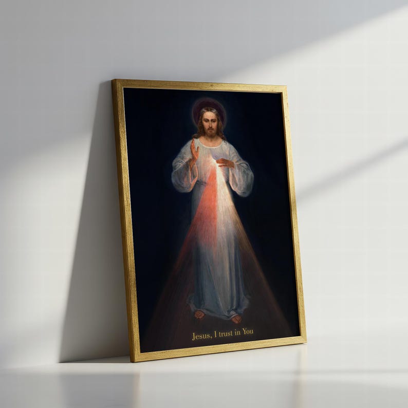 May include: A framed religious print featuring a depiction of Jesus with a halo, dressed in white robes. Light emanates from his chest, with the text "Jesus, I trust in You" at the bottom. The frame is gold.