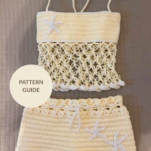 May include: Cream-colored crochet top and shorts set. The top has a solid band with straps and a decorative openwork design. White starfish appliqués adorn the top and shorts. The text "PATTERN GUIDE" is visible on a circular label.