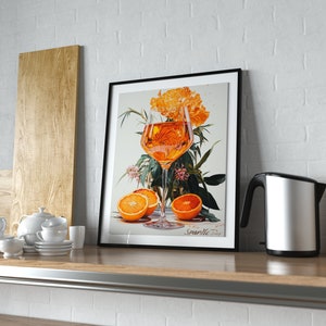 May include: A framed print of a still life featuring a glass of orange juice, orange slices, and a bouquet of orange flowers. The print is titled "Sparkle Today".