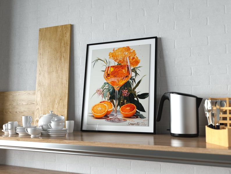 May include: A framed print of a still life featuring a glass of orange juice, orange slices, and a bouquet of orange flowers. The print is titled "Sparkle Today".