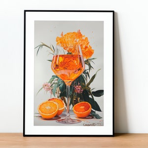 May include: A framed illustration of a glass of orange juice with orange slices and orange blossoms. The illustration is in a black frame and has the artist's signature "Svanile" in the bottom right corner.