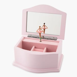 May include: A pink wooden ballerina music box with a mirror inside the lid. A ballerina figurine spins on a platform inside the box.