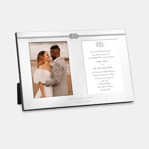 May include: A silver picture frame with a knotted rope design. The frame holds two photos, one of a couple and the other of a wedding invitation. The invitation text reads: "Mr. and Mrs. Charles Edward request the honor of your presence at the Nuptial Mass uniting their daughter Katlyn Lynn and Mr. Harvey James Bailey in the Sacrament of Holy Matrimony Saturday, the twenty-first of May Two thousand twenty-two The Lady Chapel Saint Patrick's Cathedral New York City"
