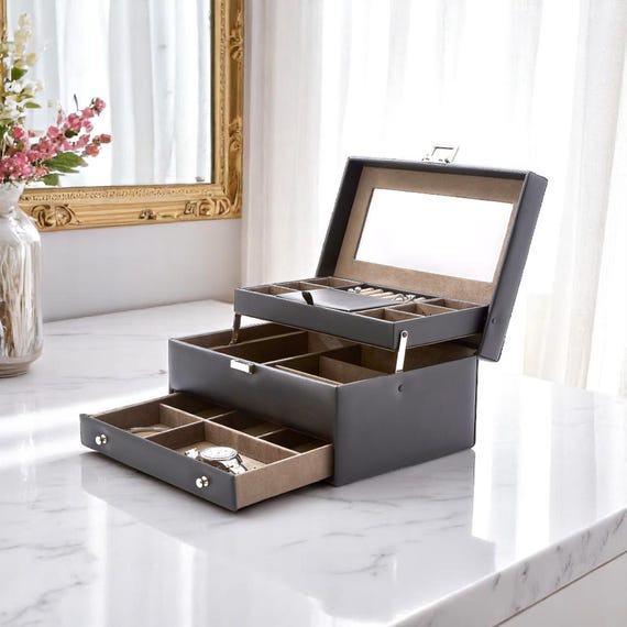 A laser-engraved expanding vegan leather jewelry box with a mirror and drawer — practical organization that actually looks like a keepsake.