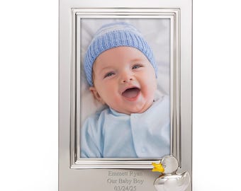 May include: Silver-plated photo frame with a baby boy in a blue hat and a yellow duck figurine. The frame is engraved with the text "Emmett Ryan Our Baby Boy 03/24/25".