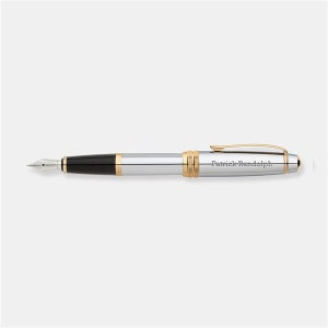 May include: A silver and gold fountain pen with a black ink cartridge. The pen is engraved with the name "Patrick Randolph".