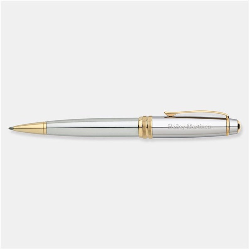 May include: A silver and gold pen with the name "Hailey Martinez" engraved on the side.