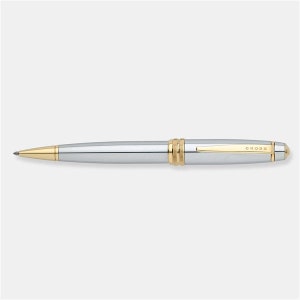 May include: A silver and gold Cross pen with a classic design. The pen has a gold band near the tip and the word "CROSS" is engraved on the barrel.