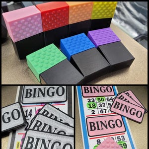 May include: A collection of colorful bingo daubers and bingo cards. The daubers are in various colors, including pink, red, orange, yellow, green, blue, and purple. The bingo cards have the word "BINGO" printed on them.