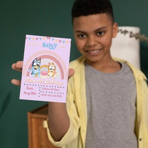 May include: A pink and purple birthday invitation with a cartoon image of Bluey and Bingo from the show Bluey. The invitation says "Mia's 7th Birthday" and includes the date and time of the party.