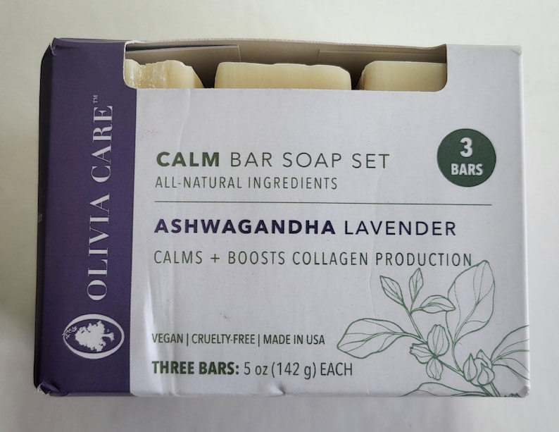 May include: A box set of three bars of soap. The box is white with purple accents and features the text "CALM BAR SOAP SET" and "ASHWAGANDHA LAVENDER". The bars are 5 oz (142 g) each and are all-natural ingredients.