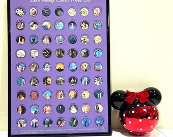 May include: A framed poster with a purple background and a list of Disney classic movies in circles. The poster has the title "Lisa's Disney Classic Movie List" and a quote at the bottom that says "If you can dream it, you can do it. Always remember that this whole thing was started with a dream and a mouse."