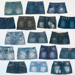 May include: A collection of 15 denim mini skirts in various shades of blue, black, and grey. Some skirts have distressed details, while others have embellishments like studs or stitching.