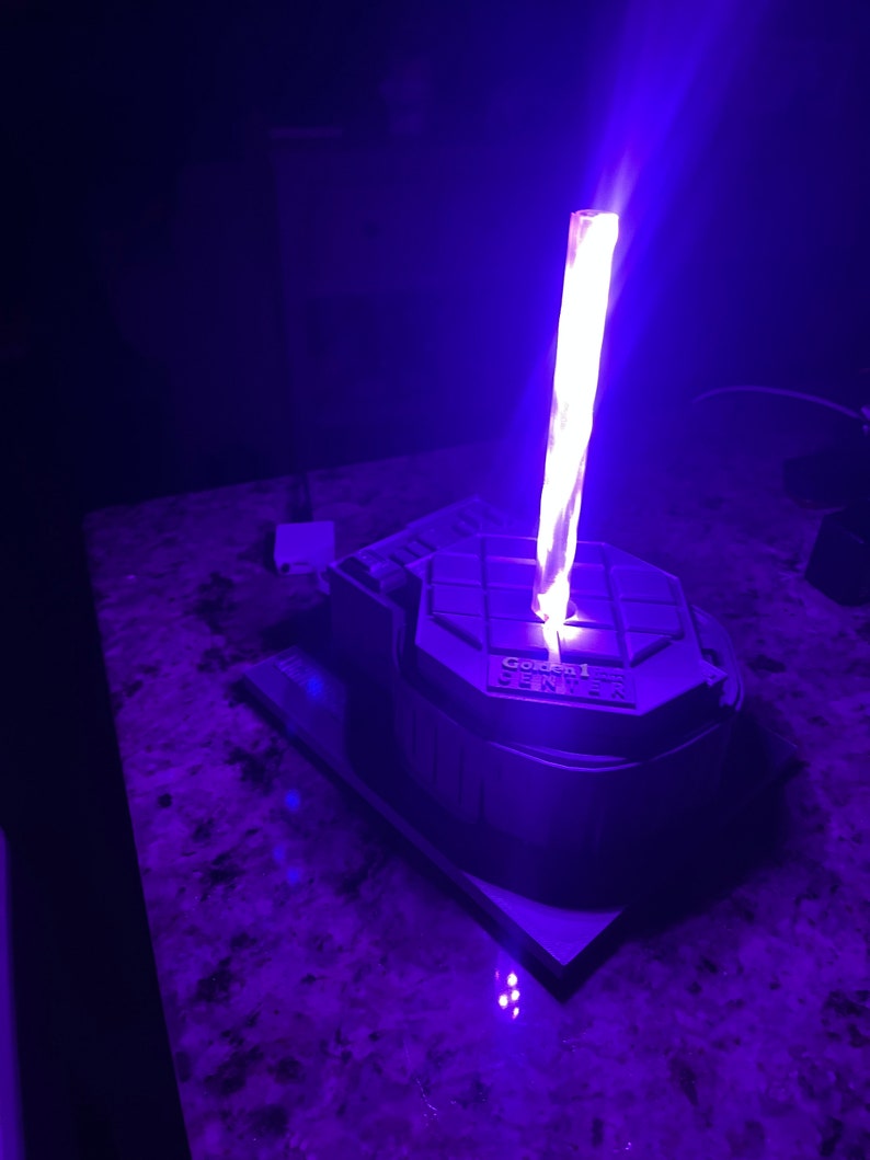 May include: A 3D printed model of the Golden 1 Center, home of the Sacramento Kings, with a purple light shining from the top.