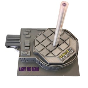 May include: A gray 3D printed model of the Golden 1 Credit Union Center, home of the Sacramento Kings. The model has a clear plastic tube sticking out of the top, and the words "LIGHT THE BEAM" are printed on the base.