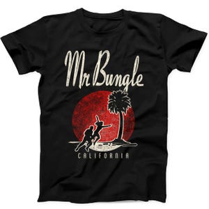May include: A black short-sleeve t-shirt featuring the white text Mr Bungle above a red circular sun graphic with a black silhouette of a palm tree and two figures running. The word CALIFORNIA is printed in white text below the graphic.