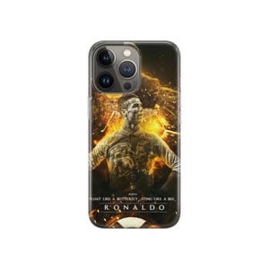 May include: Clear phone case with a portrait of Cristiano Ronaldo and a fiery background. The case has the text "FLOAT LIKE A BUTTERFLY, STING LIKE A BEE, RONALDO" in white. The phone case is designed for a smartphone.