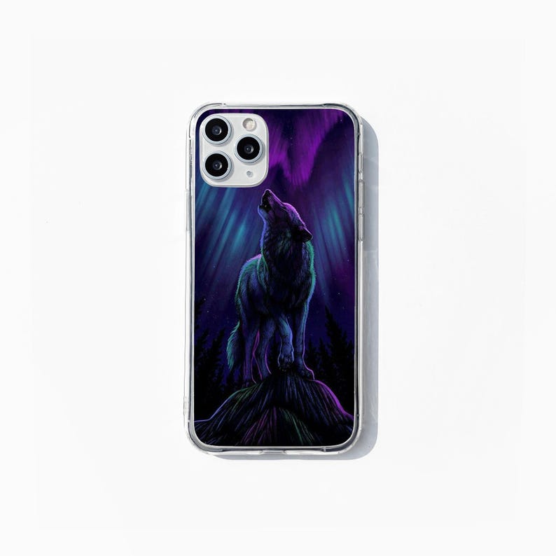 May include: Clear phone case with a design of a howling wolf against a purple and teal aurora borealis. The image includes a dark forest at the bottom. The case is designed for a smartphone.