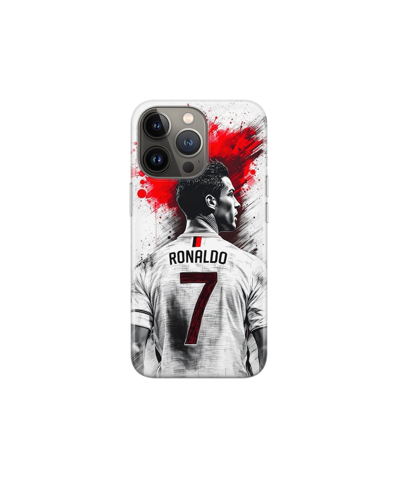 May include: A white phone case with a graphic of a soccer player in a white jersey. The jersey displays the name "RONALDO" and the number "7" in red. A red splash design is in the background, adding a dynamic element.