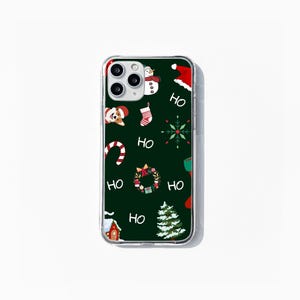 May include: A clear phone case with a green background and a Christmas-themed design. The design features a snowman, a stocking, a candy cane, a wreath, a Christmas tree, and the word "HO" repeated several times.