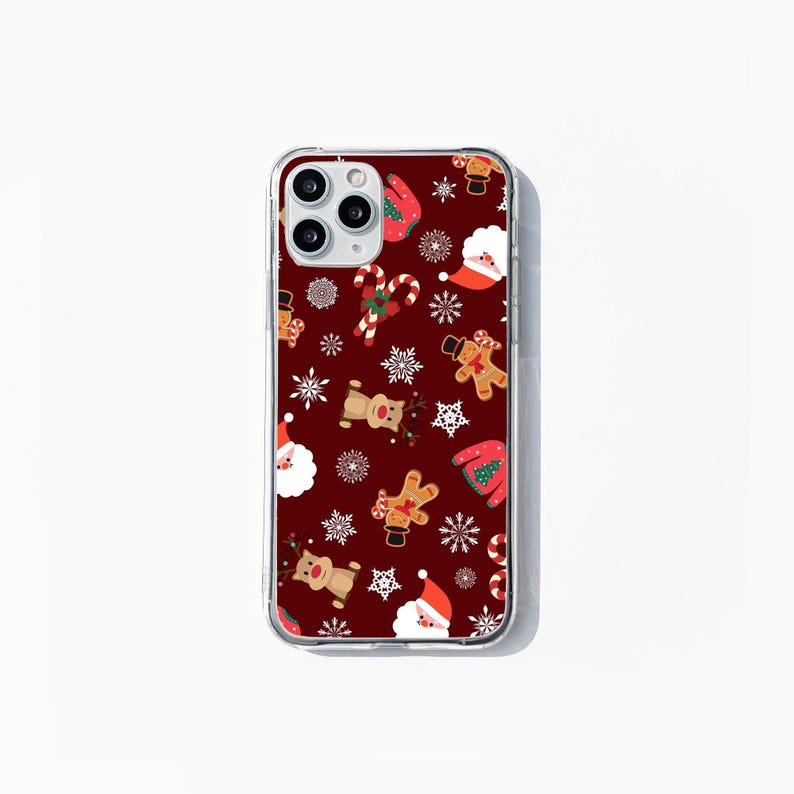 May include: A clear phone case with a red background and a Christmas pattern. The pattern includes Santa Claus, reindeer, gingerbread men, candy canes, and snowflakes.