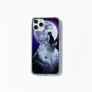 May include: Transparent phone case with a design of a howling wolf under a full moon and a starry night. The wolf is in grey and white, the moon in white and grey. The case is designed for a smartphone.