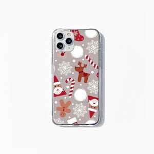 May include: A clear phone case with a Christmas-themed design. The case features a pattern of snowflakes, candy canes, reindeer, Santa Claus, and gingerbread men on a light gray background.