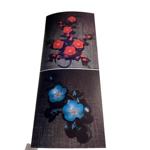 May include: Two images of floral arrangements made of fabric. The top image shows a red floral arrangement with a dark background. The bottom image shows a blue floral arrangement with a dark background.
