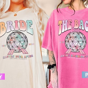 Op de afbeelding: Twee T-shirts met een kleurrijke afbeelding van de Spaceship Earth-attractie in Epcot. Het ivoorwitte shirt heeft de tekst "Bride" en "Happily Ever After" met de datum "EST 2024". Het roze shirt heeft de tekst "The Bach Club" en "Anna's Bachelorette" met de datum "EST 2024".