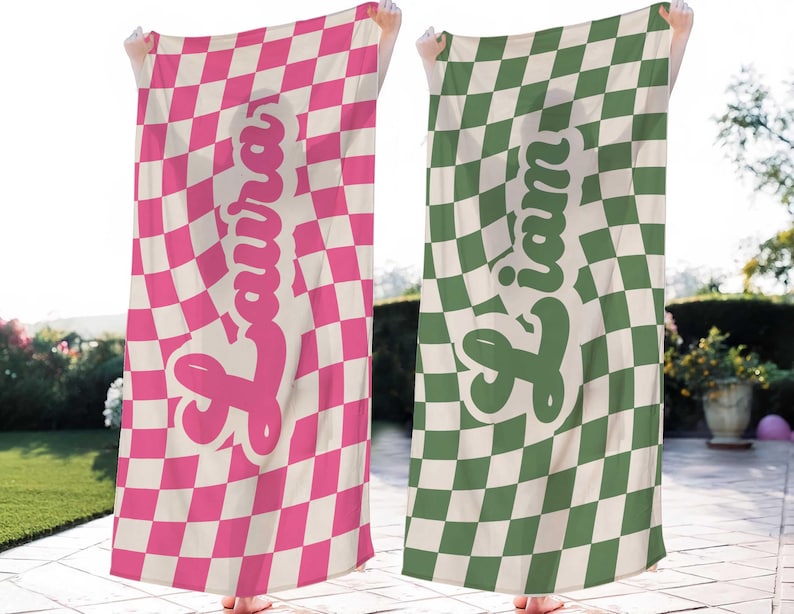 May include: Two beach towels with a checkered pattern in pink and white and green and white. The towels have a name written on them in a retro font. The names are "Laura" and "Liam".