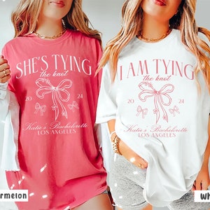 Coquette Bow Bachelorette Shirts, She&#39;s Tying the Knot Bridal Party, Custom Bachelorette Party Shirt, Custom Location, Bridal Shower Gifts