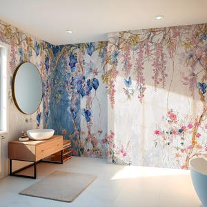 May include: A bathroom with floral wallpaper featuring pink, blue, and yellow flowers and vines. The room includes a wooden vanity with a round mirror, a white sink, and a freestanding bathtub. A window provides natural light.