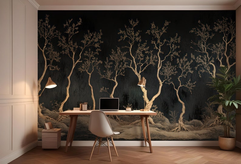 May include: A home office with a black and gold wallpaper featuring a stylized tree design. A wooden desk with a laptop, a white chair, and two lamps is in front of the wallpaper. A potted plant is in the corner of the room.