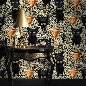 May include: Black cats with bow ties are featured on a gold and black leopard print wallpaper. A gold lamp sits on a black table with a gold trim. A black rotary phone is on the table.