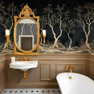 May include: A gold-framed ornate mirror hangs above a white porcelain pedestal sink with gold fixtures in a bathroom with black and gold wallpaper featuring a stylized tree design. A white porcelain bathtub with gold fixtures is in the lower right corner of the image.