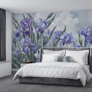May include: A white bed with a gray headboard and a white comforter. The bed is in front of a wall with a mural of purple irises on a light blue background.