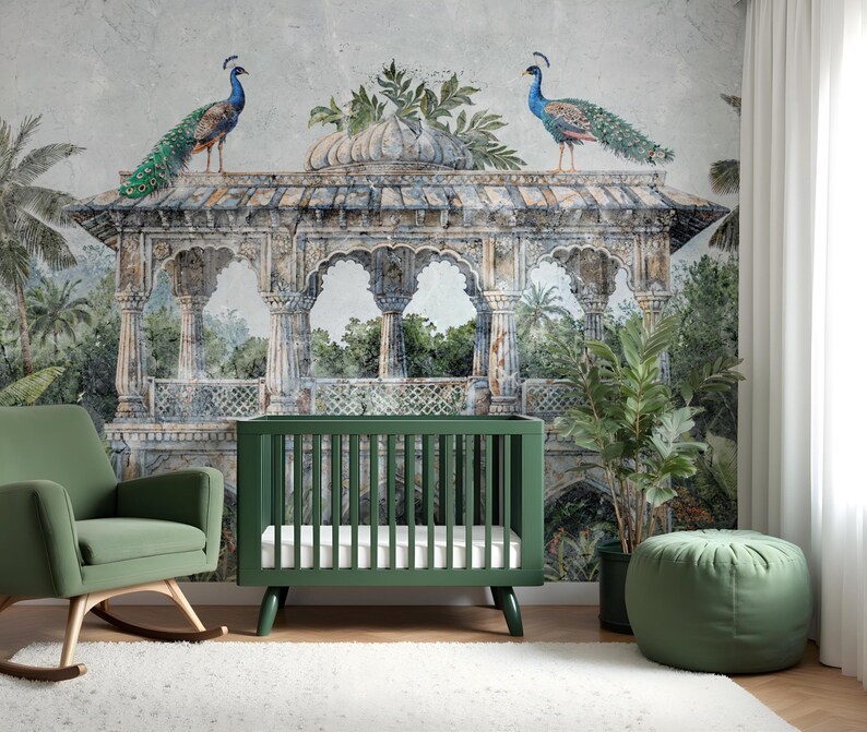 May include: A green cot and rocking chair in a nursery with a mural of a temple and peacocks. A green ottoman and potted plant are also in the room. The cot has a white mattress. The mural has a vintage, watercolour style.