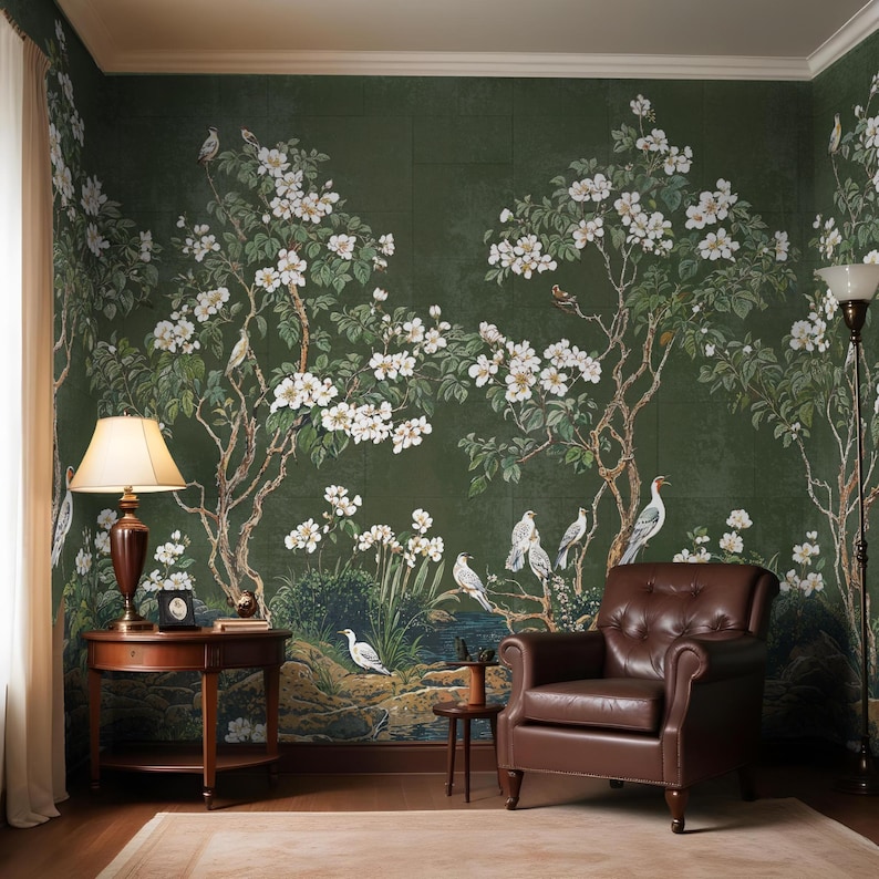 May include: A green wallpaper with a floral design featuring white flowers and birds. The wallpaper is in a living room with a brown leather armchair and a side table.