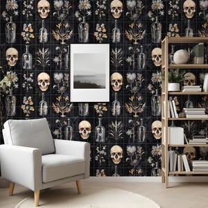 May include: Black and white wallpaper with a repeating pattern of skulls, flowers, and bottles. The wallpaper is in a room with a white armchair and a wooden bookshelf.