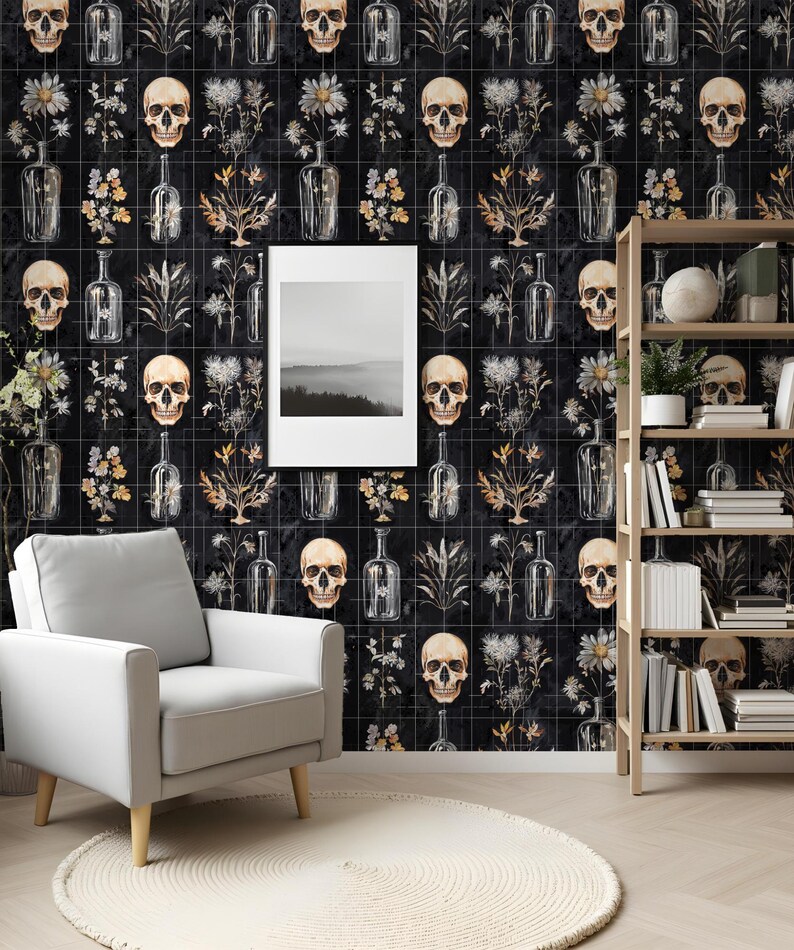 May include: Black and white wallpaper with a repeating pattern of skulls, flowers, and bottles. The wallpaper is in a room with a white armchair and a wooden bookshelf.