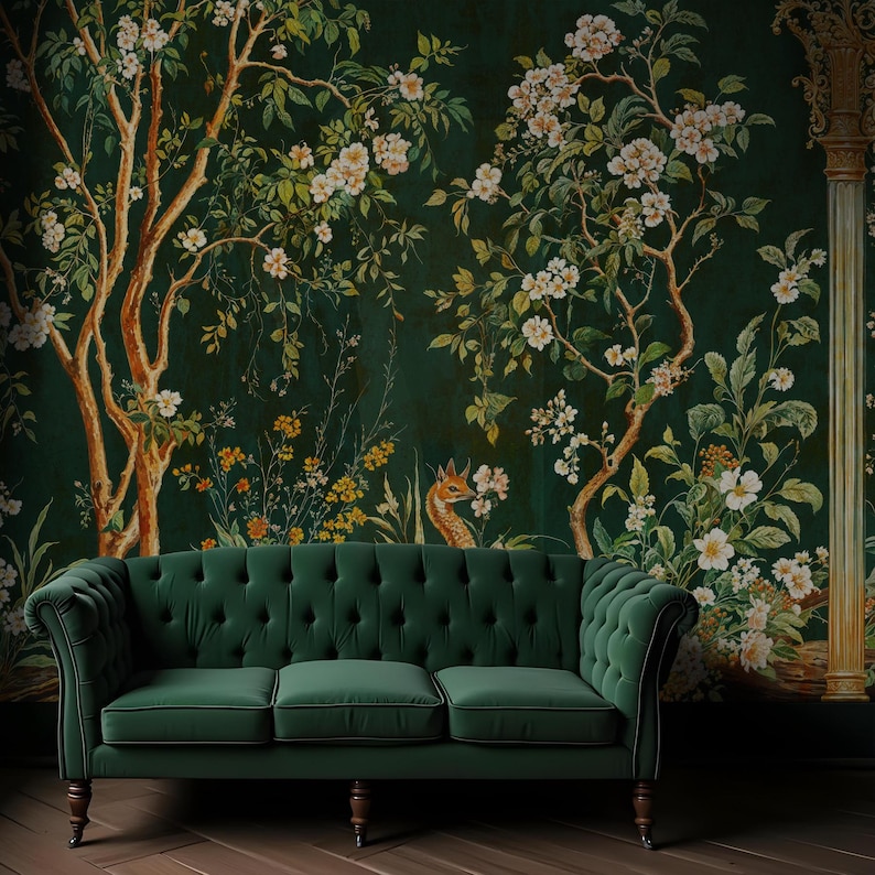 May include: A dark green velvet sofa with button tufting sits in front of a wall with a floral wallpaper featuring white flowers, green leaves, and a small deer.