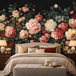 May include: A bedroom with a floral wallpaper featuring large, colorful flowers in shades of red, pink, and white against a dark background. The bed has a beige comforter and pillows. Two lamps flank the bed.