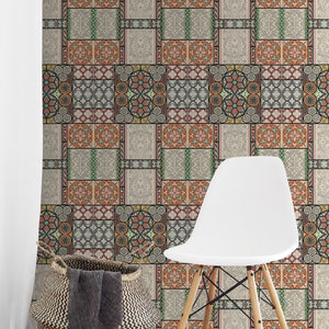 May include: A white chair with wooden legs sits in front of a wall covered in patterned wallpaper. The wallpaper features a repeating design of colorful geometric shapes and patterns, reminiscent of traditional tilework.