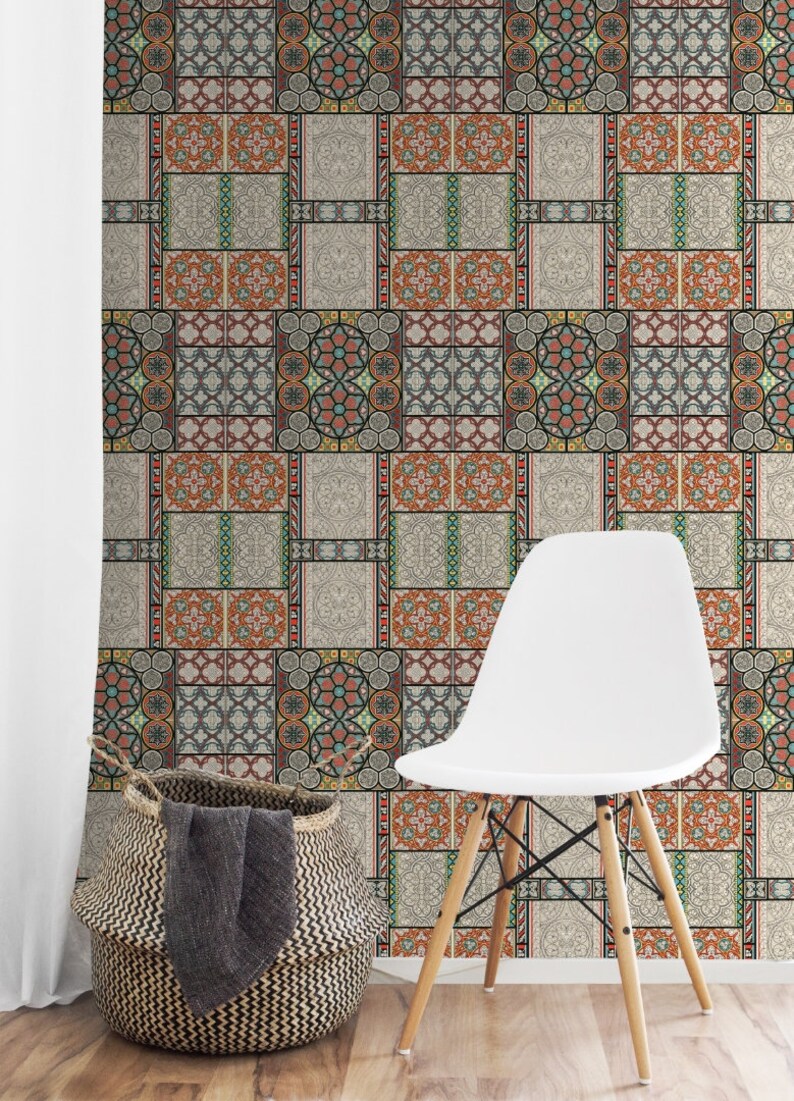 May include: A white chair with wooden legs sits in front of a wall covered in patterned wallpaper. The wallpaper features a repeating design of colorful geometric shapes and patterns, reminiscent of traditional tilework.