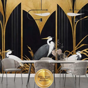 May include: A dining room scene featuring a black and gold metallic wallpaper with a heron design. The wallpaper has a stylized art deco design with gold accents. The room includes a white table, gray chairs, and decorative lighting.