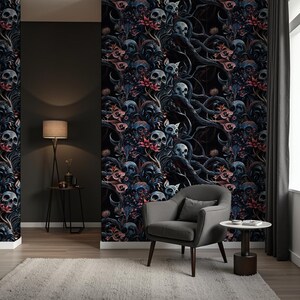 May include: A dark blue and black wallpaper with a repeating pattern of skulls, flowers, and vines. The wallpaper is shown in a room with a gray armchair and a side table.