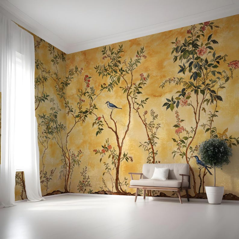 May include: A yellow wallpaper with a floral pattern and blue birds. The wallpaper is in a room with a white sofa and a potted plant.