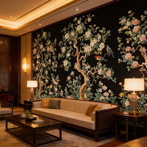 May include: A luxurious living room featuring a black floral mural with pink and white blossoms and birds. A beige sofa with decorative pillows sits in front of the mural. The room includes a dark wood coffee table, chairs, and lamps.